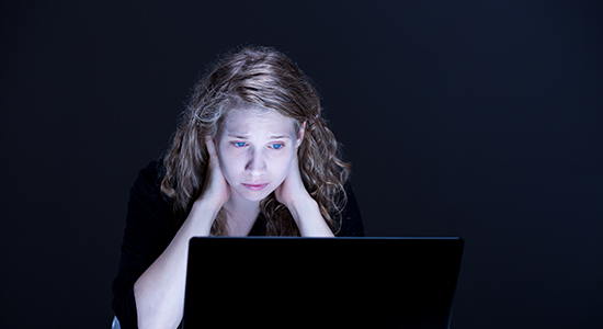 Sad female victim of online stalking.